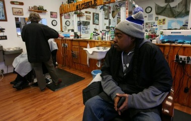 Victor Burch, 40, waits for customers in his barber shop in Livonia, Michigan, U.S. January 24, 2020. Picture taken January 24, 2020. REUTERS/Michael Martina
