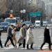 People wearing masks to prevent the coronavirus walk on a pedestrian crossing in downtown Seoul, South Korea, February 24, 2020.    REUTERS/Heo Ran