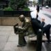 A man rests on the "Double Check" sculpture in the financial district, during the outbreak of the coronavirus disease (COVID-19) in New York City, New York, U.S. April 23, 2020. REUTERS/Eduardo Munoz
