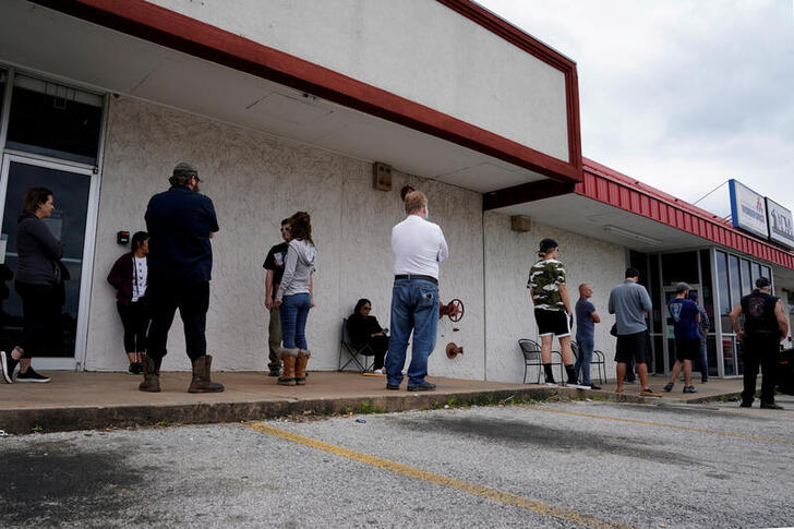 FILE PHOTO: People who lost their jobs wait in line to file for unemployment following an outbreak of the coronavirus disease (COVID-19), at an Arkansas Workforce Center in Fayetteville, Arkansas, U.S. April 6, 2020. REUTERS/Nick Oxford/File Photo