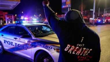 A man stands in front of a police car during the protest against the deaths of Breonna Taylor by Louisville police and George Floyd by Minneapolis police, in Louisville, Kentucky, U.S. June 1, 2020. Picture taken June 1, 2020. REUTERS/Bryan Woolston