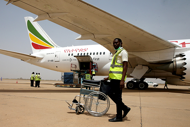 An airport worker pushes a wheelchair after an Ethiopian Airlines aircraft arrived at the newly renovated Kaduna airport in Kaduna, Nigeria March 8, 2017. REUTERS/Afolabi Sotunde - RTS11ZG6