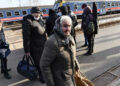 Ukrainian people leave a train that carried 275 people, to arrive in Zahony, Hungary, a border town with Ukraine, Friday, Feb. 25, 2022. Thousands of Ukrainians are fleeing from war by crossing their borders to the west in search of safety. They left their country as Russia pounded their capital and other cities with airstrikes for a second day on Friday. (AP Photo/Anna Szilagyi)