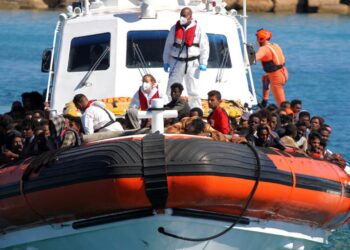 Migrants approach aboard a search-and-rescue boat after hundreds arrive on the southern island of Lampedusa, Italy May 9, 2021. Picture taken May 9, 2021. REUTERS/Mauro Buccarello NO RESALES. NO ARCHIVES